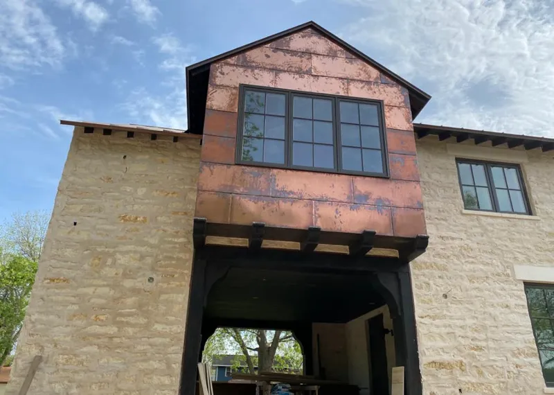 Copper metal panel facade on a stone building for Skylight Installation in Winchendon